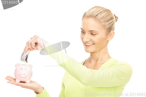 Image of woman with piggy bank and money