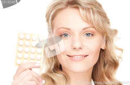 Image of young woman with pills