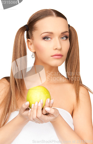 Image of young beautiful woman with green apple