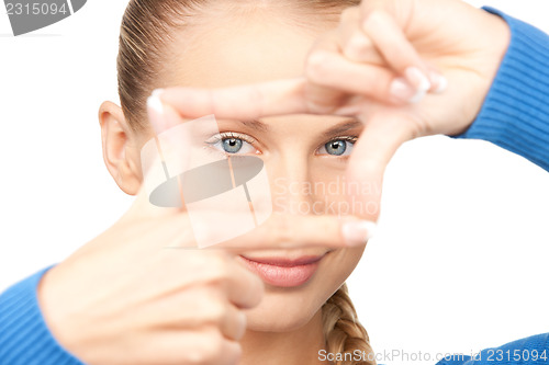 Image of lovely woman creating a frame with fingers