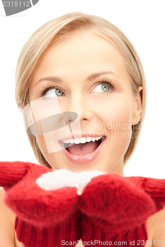 Image of beautiful woman in red mittens with snow