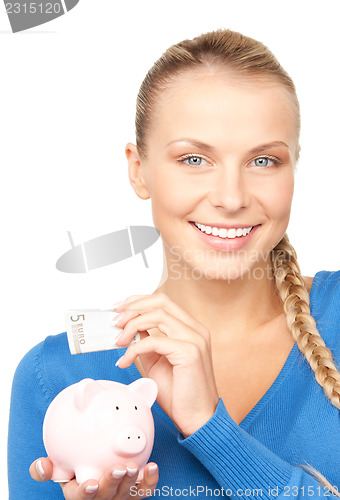 Image of lovely woman with piggy bank and money
