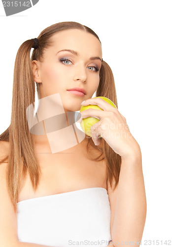 Image of young beautiful woman with green apple
