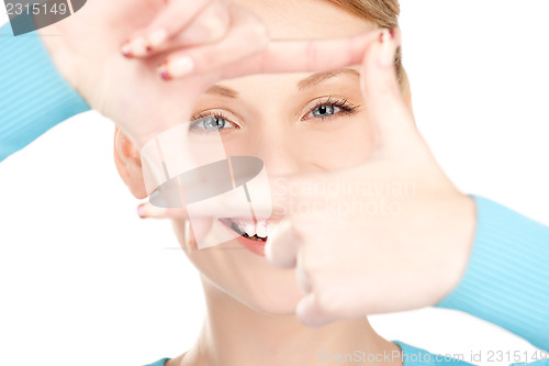 Image of lovely woman creating a frame with fingers