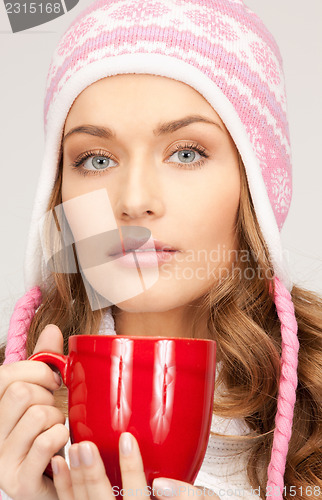 Image of beautiful woman with red mug