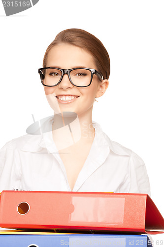 Image of young attractive businesswoman with folders