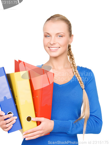 Image of young attractive businesswoman with folders