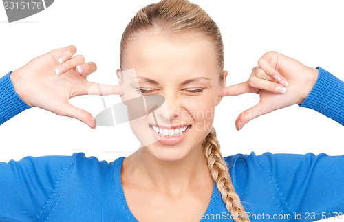 Image of smiling woman with fingers in ears