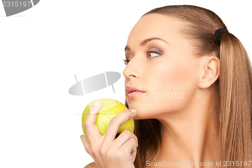 Image of young beautiful woman with green apple
