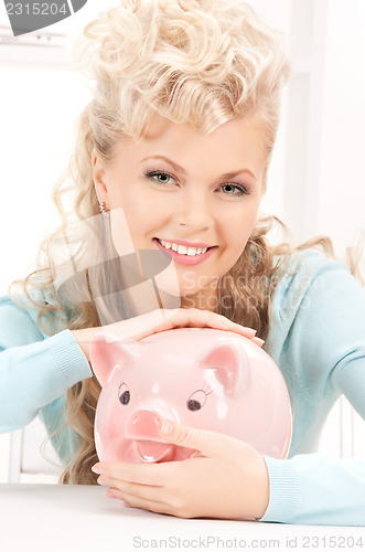 Image of lovely woman with piggy bank