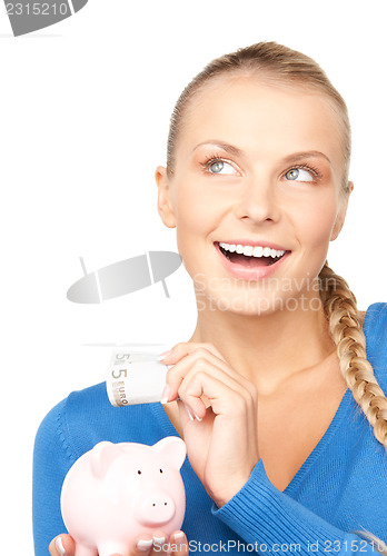 Image of lovely woman with piggy bank and money