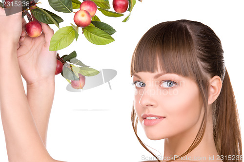 Image of lovely woman with apple twig