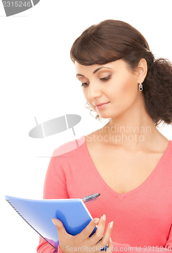 Image of young attractive businesswoman with notebook