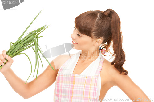 Image of beautiful housewife with spring onions over white