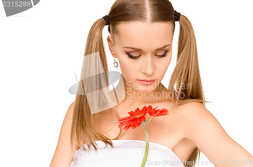 Image of woman in towel with red flower