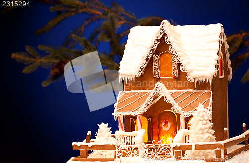 Image of gingerbread house over christmas background