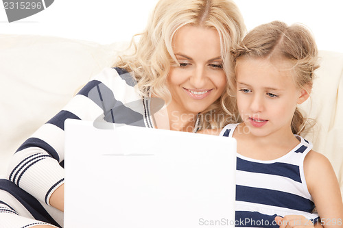 Image of happy mother and child with laptop computer