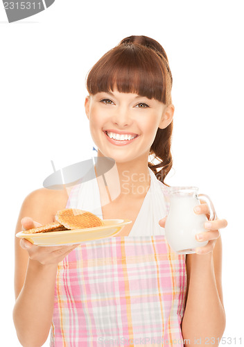 Image of housewife with milk and cookies