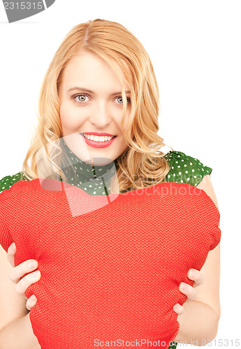Image of woman with red heart-shaped pillow