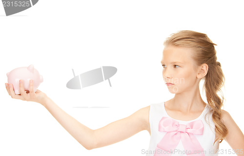 Image of lovely teenage girl with piggy bank