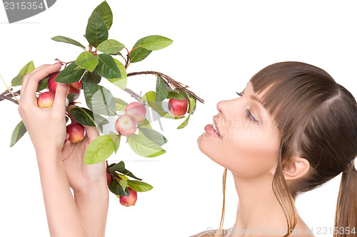 Image of lovely woman with apple twig