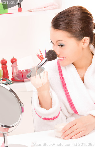 Image of lovely woman with brush and mirror