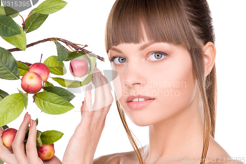 Image of lovely woman with apple twig