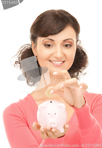 Image of lovely woman with piggy bank and money