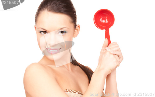 Image of beautiful housewife with red ladle 