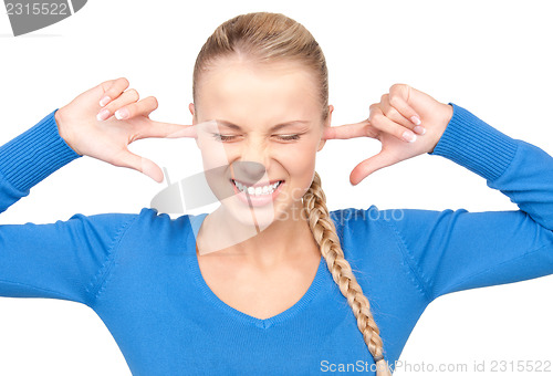 Image of smiling woman with fingers in ears