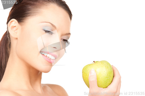 Image of young beautiful woman with green apple