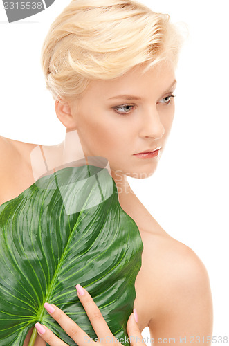 Image of woman with green leaf