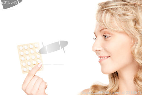 Image of young woman with pills