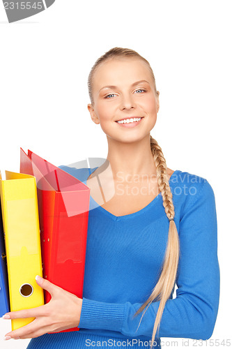 Image of young attractive businesswoman with folders