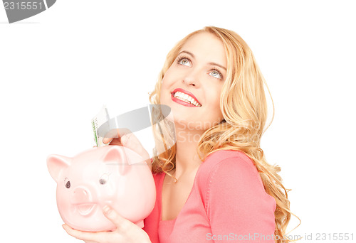 Image of lovely woman with piggy bank and money