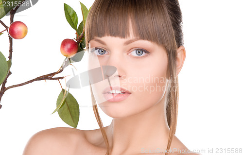 Image of lovely woman with apple twig