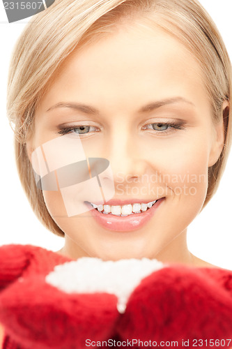 Image of beautiful woman in red mittens with snow