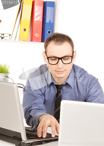 Image of businessman with laptop computer in office