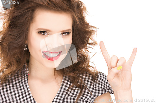 Image of happy teenage girl showing devil horns gesture