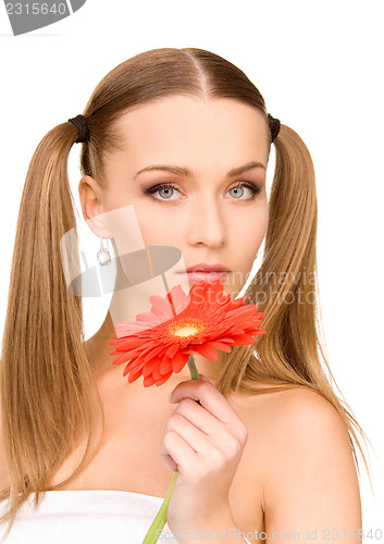 Image of woman in towel with red flower