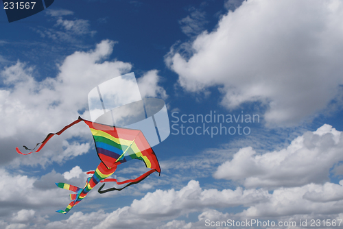 Image of Colorful kite in cloudy sky
