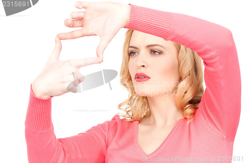 Image of lovely woman creating a frame with fingers              