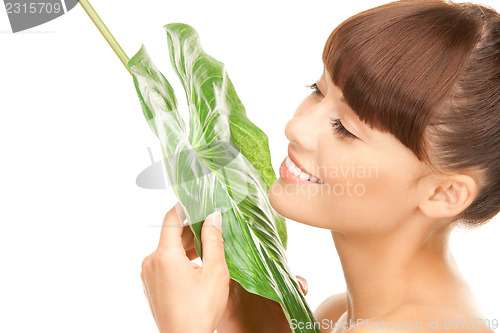 Image of woman with green leaf