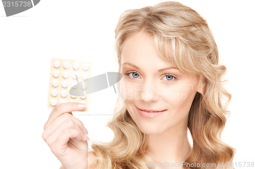 Image of young woman with pills