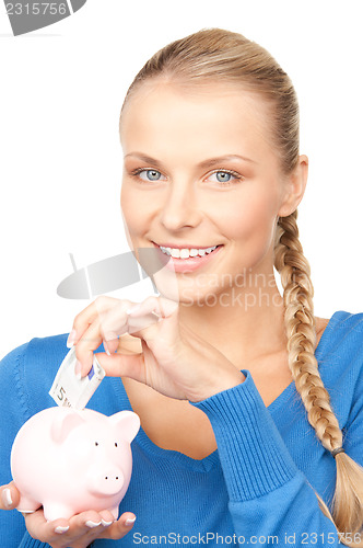 Image of lovely woman with piggy bank and money