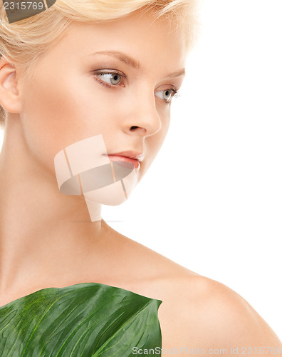 Image of woman with green leaf