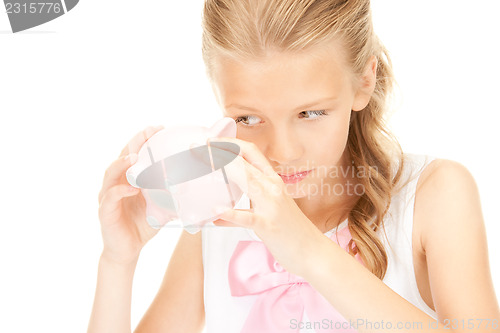 Image of lovely teenage girl with piggy bank