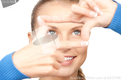 Image of lovely woman creating a frame with fingers