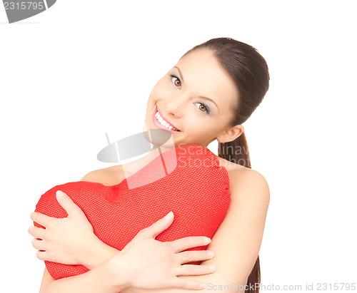 Image of woman with red heart-shaped pillow over white 