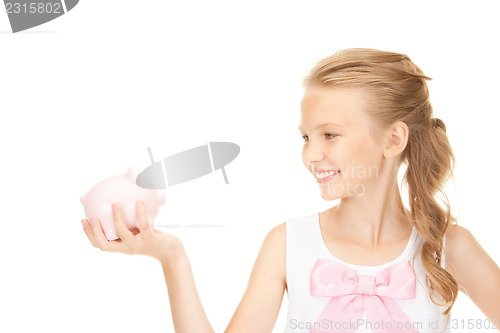 Image of lovely teenage girl with piggy bank
